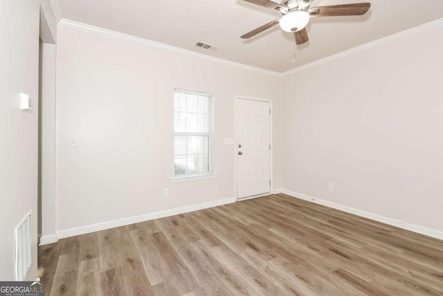 unfurnished room with ceiling fan, light hardwood / wood-style flooring, and ornamental molding