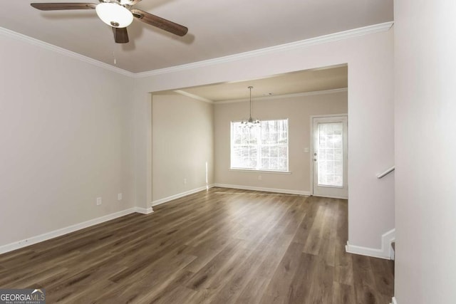 unfurnished room featuring ceiling fan with notable chandelier, dark hardwood / wood-style floors, and crown molding