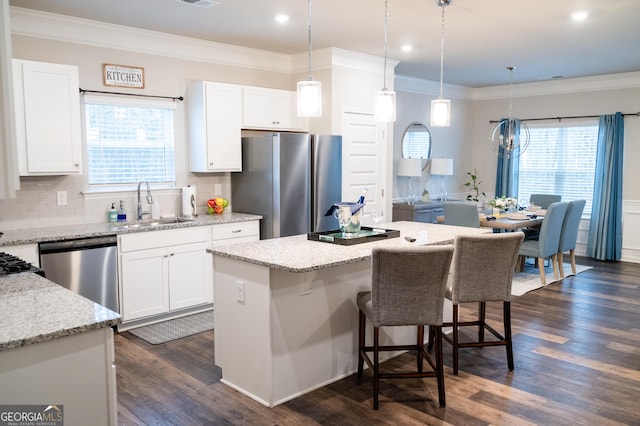 kitchen featuring appliances with stainless steel finishes, a center island, and white cabinets