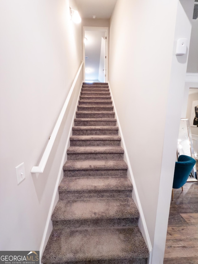 stairs with wood-type flooring