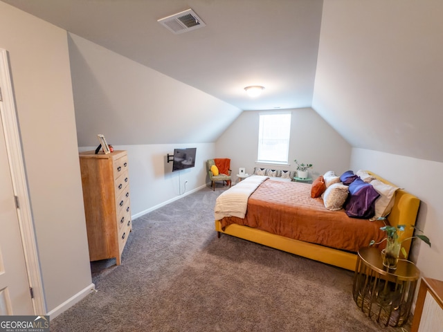 carpeted bedroom with lofted ceiling