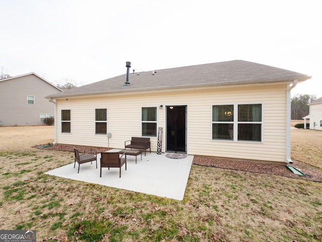 back of property with a yard and a patio area