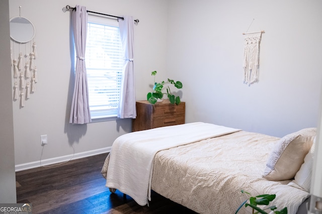 bedroom with dark hardwood / wood-style floors