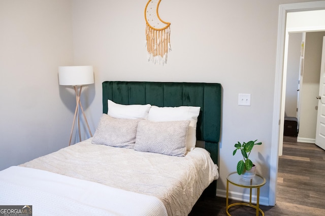 bedroom with dark hardwood / wood-style flooring