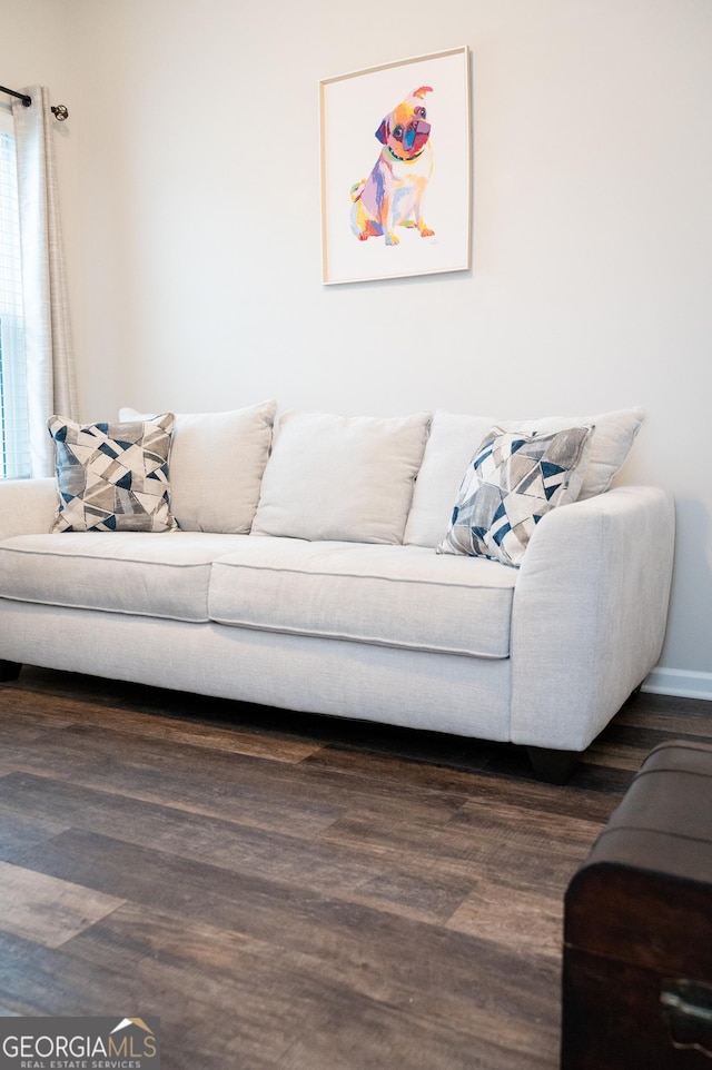 living room with a healthy amount of sunlight and dark hardwood / wood-style flooring