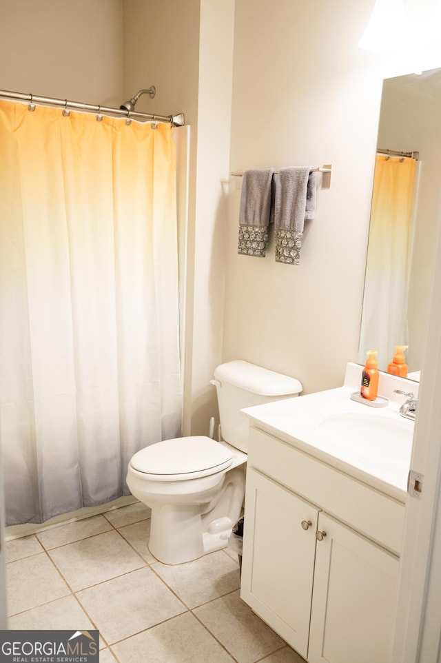 bathroom featuring vanity, toilet, and tile patterned flooring