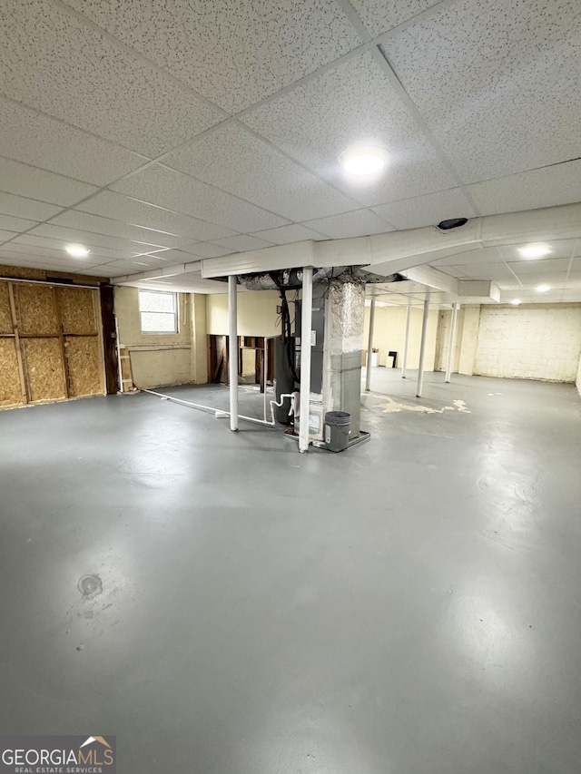 basement featuring a paneled ceiling