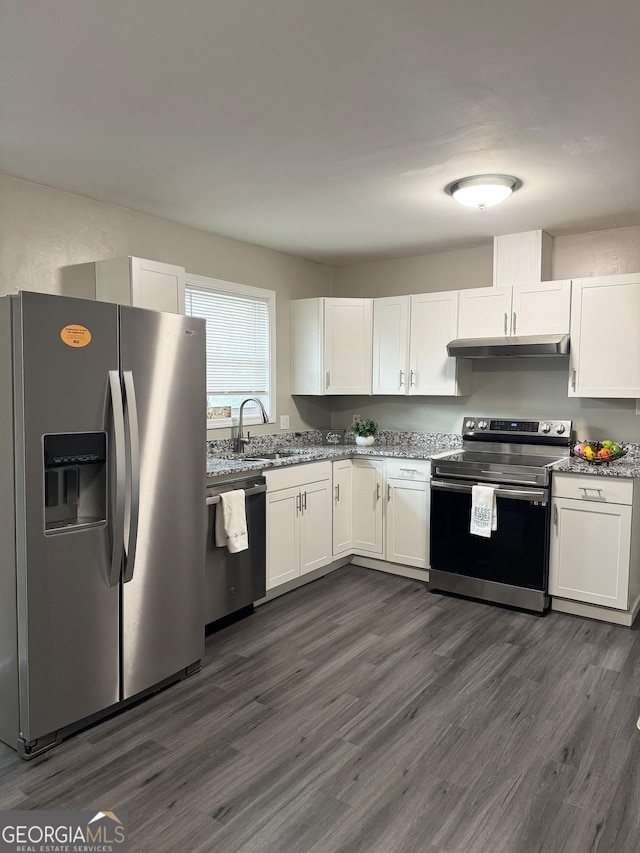 kitchen with dark hardwood / wood-style floors, sink, white cabinets, stainless steel appliances, and light stone countertops