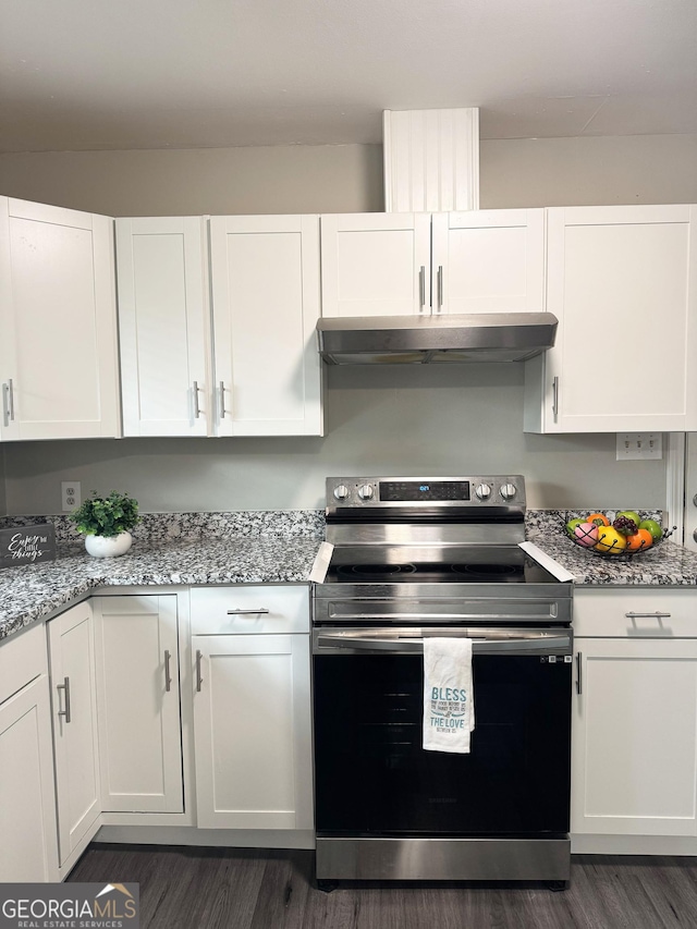 kitchen featuring white cabinetry, stainless steel electric range oven, light stone countertops, and dark hardwood / wood-style floors