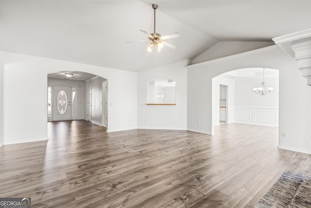 unfurnished living room with wood-type flooring, vaulted ceiling, and ceiling fan with notable chandelier