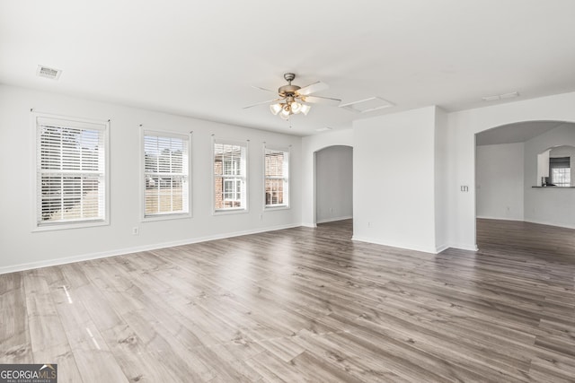 empty room with hardwood / wood-style flooring and ceiling fan