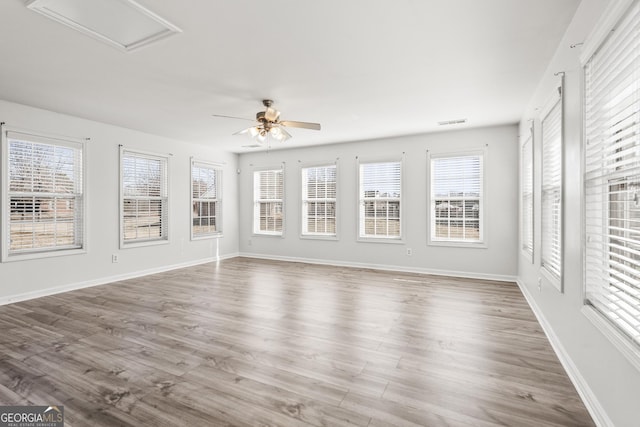 unfurnished sunroom featuring ceiling fan