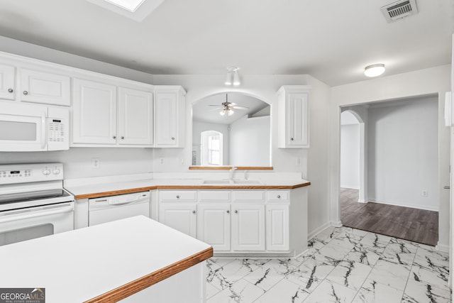 kitchen with ceiling fan, sink, white cabinets, and white appliances