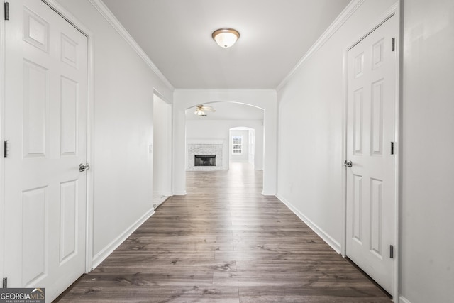 hall featuring ornamental molding and dark wood-type flooring