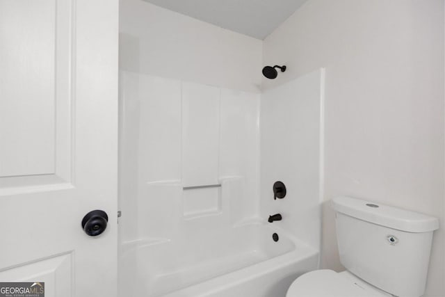 bathroom with toilet and washtub / shower combination