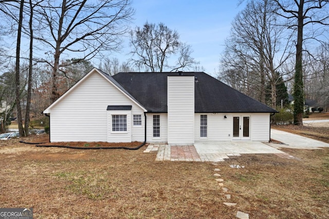 rear view of property with a patio and a yard