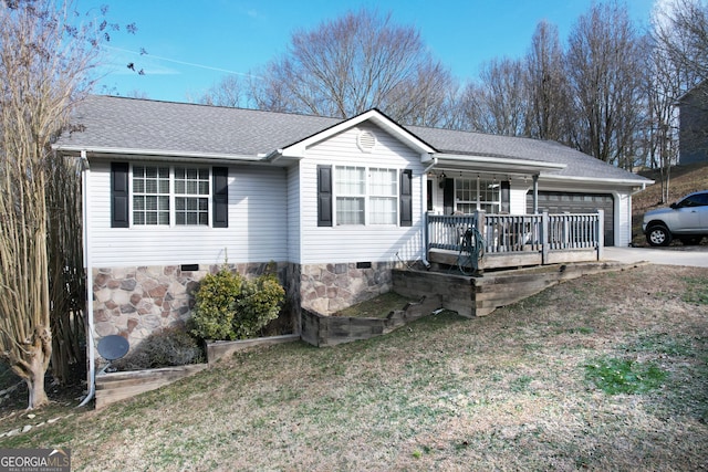 ranch-style house with a garage and covered porch