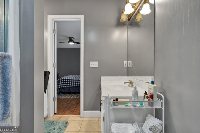 bathroom with vanity, a notable chandelier, and tile patterned floors