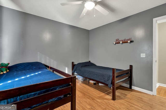 bedroom with hardwood / wood-style flooring and ceiling fan