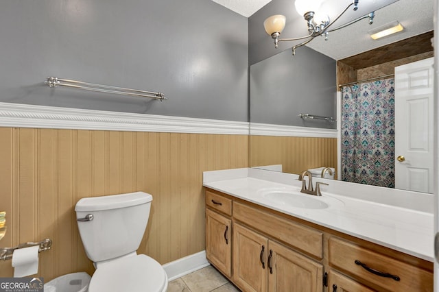 bathroom featuring tile patterned flooring, vanity, toilet, a textured ceiling, and a shower with shower curtain