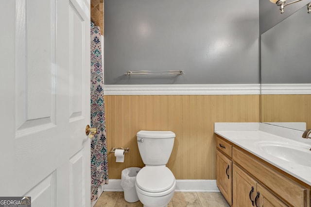 bathroom with tile patterned flooring, vanity, and toilet