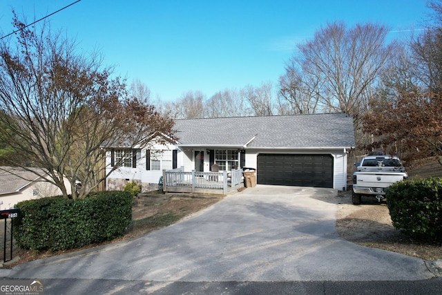 ranch-style house featuring a porch and a garage