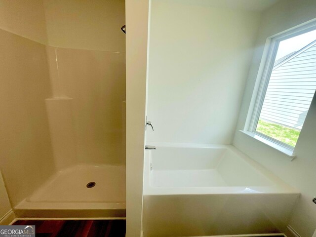 bathroom featuring wood-type flooring, a bathing tub, and vanity