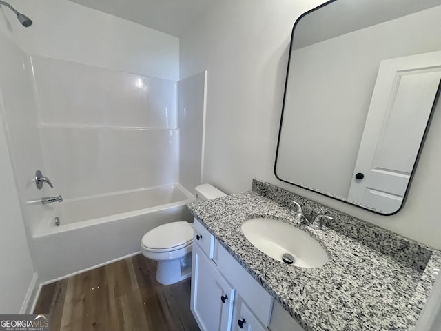 full bathroom featuring toilet, shower / tub combination, wood finished floors, and vanity