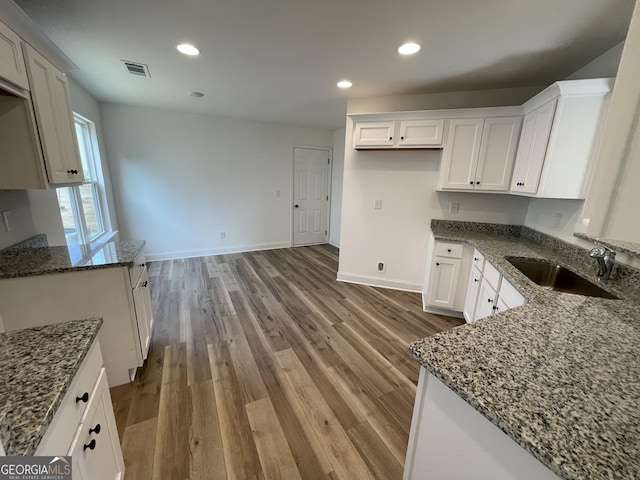 unfurnished living room featuring high vaulted ceiling, dark hardwood / wood-style flooring, and ceiling fan with notable chandelier