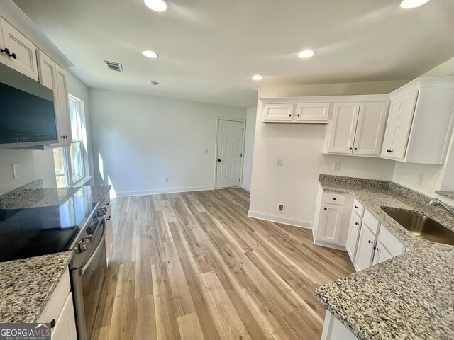 unfurnished room with a raised ceiling, ornamental molding, and dark wood-type flooring