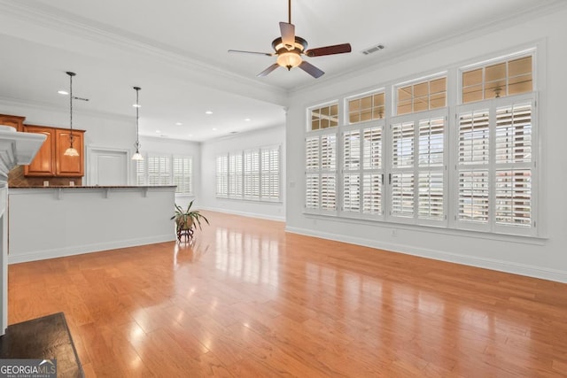 living room featuring crown molding, plenty of natural light, and ceiling fan