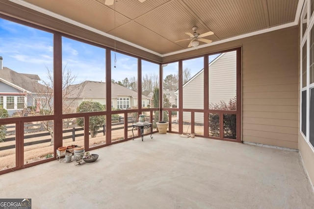 unfurnished sunroom with plenty of natural light, ceiling fan, and wood ceiling