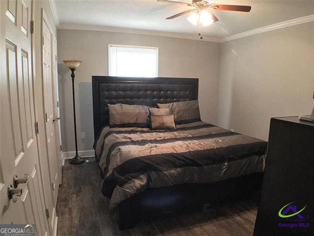 bedroom featuring ornamental molding, ceiling fan, and dark hardwood / wood-style flooring