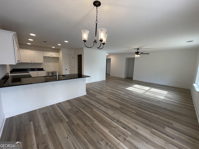 kitchen featuring decorative light fixtures, white cabinetry, dark hardwood / wood-style flooring, and ceiling fan with notable chandelier