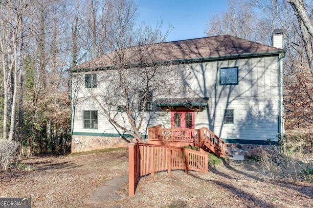 back of house with a wooden deck