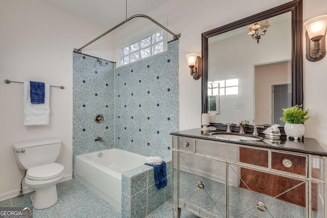 full bathroom with vanity, tile patterned flooring, toilet, and tiled shower / bath