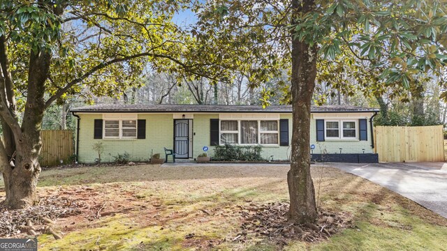 ranch-style house with a front lawn