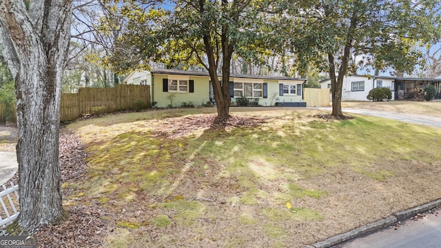 ranch-style home with a front yard