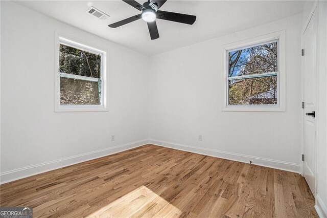 unfurnished bedroom with light wood-type flooring, ceiling fan, and a closet