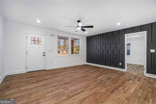 unfurnished room featuring a chandelier and light wood-type flooring