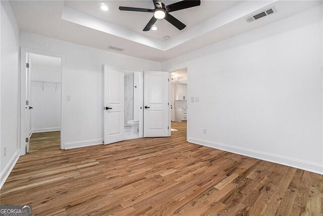 kitchen featuring hanging light fixtures, white cabinets, a center island, and stainless steel appliances