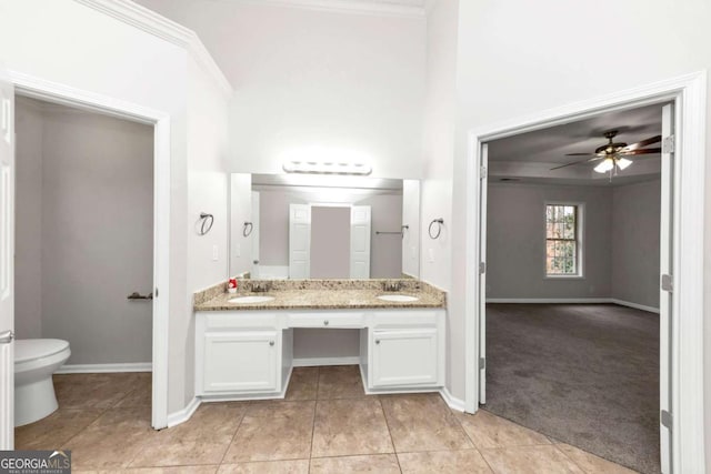 bathroom featuring crown molding, toilet, tile patterned floors, and vanity