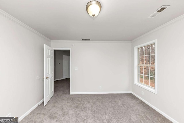 carpeted spare room with ornamental molding