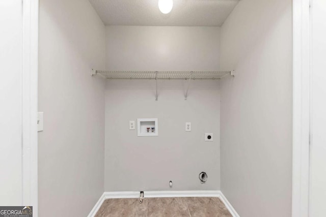 laundry area featuring washer hookup, gas dryer hookup, electric dryer hookup, and a textured ceiling