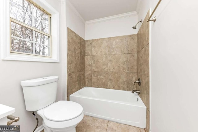 bathroom with toilet, crown molding, tile patterned flooring, and tiled shower / bath combo