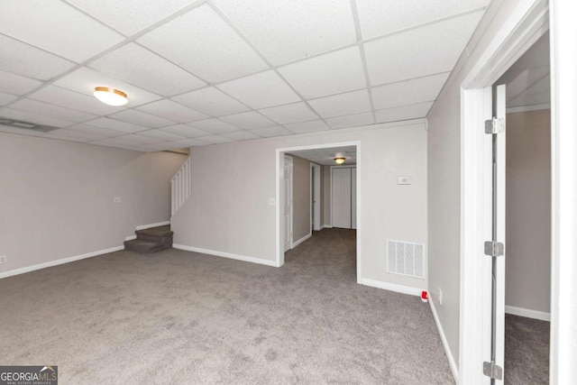 basement with carpet flooring and a paneled ceiling