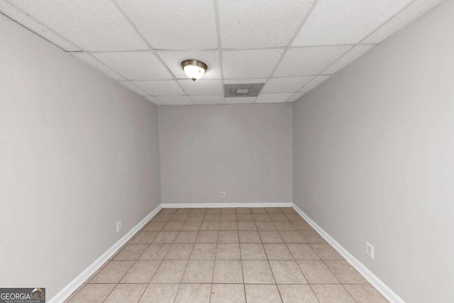 empty room featuring a drop ceiling