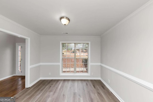 unfurnished dining area featuring crown molding and wood-type flooring