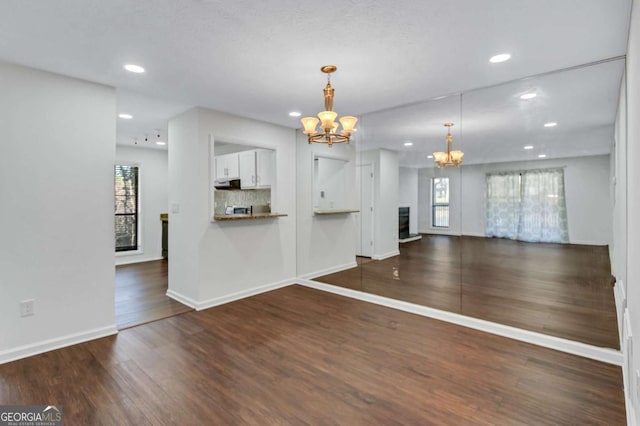 interior space with a chandelier and dark hardwood / wood-style floors