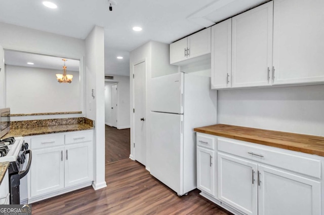 kitchen featuring white cabinets, wood counters, range with gas stovetop, and white fridge